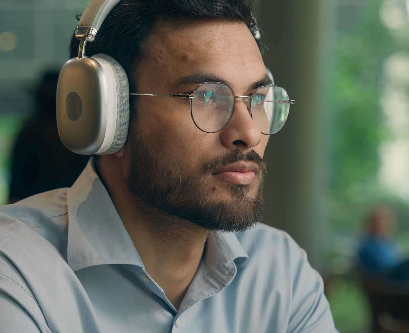 man looking at stock trades with audio order flow and headphones